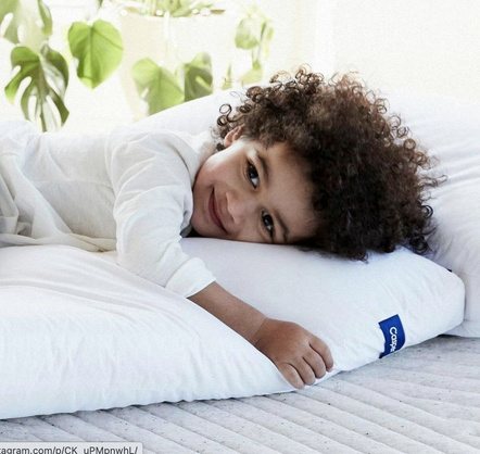 A child resting on a white pillow